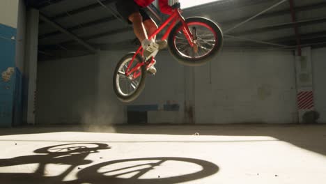 bmx rider in an empty warehouse