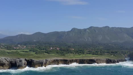 slow motion trucking aerial pan of bufones de pria asturias spain green sea cliffs