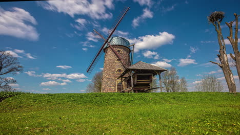 Low-angle-shot-of-old-traditional-windmill-in-Netherlands-with-white-cloud-movement-in-the-background-in-timelapse