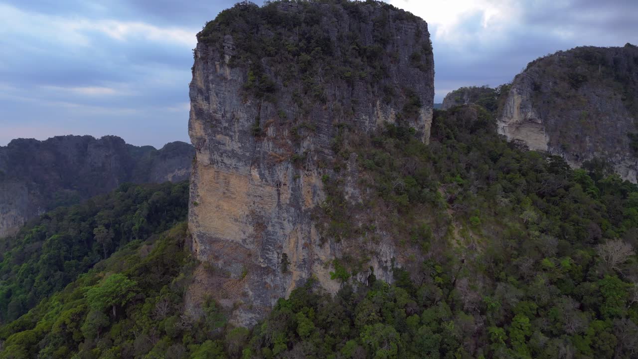 Rai Leh beach towering limestone cliffs emerging from tropical forest in Krabi, Thailand. Lovely aerial view flight overflight flyover drone