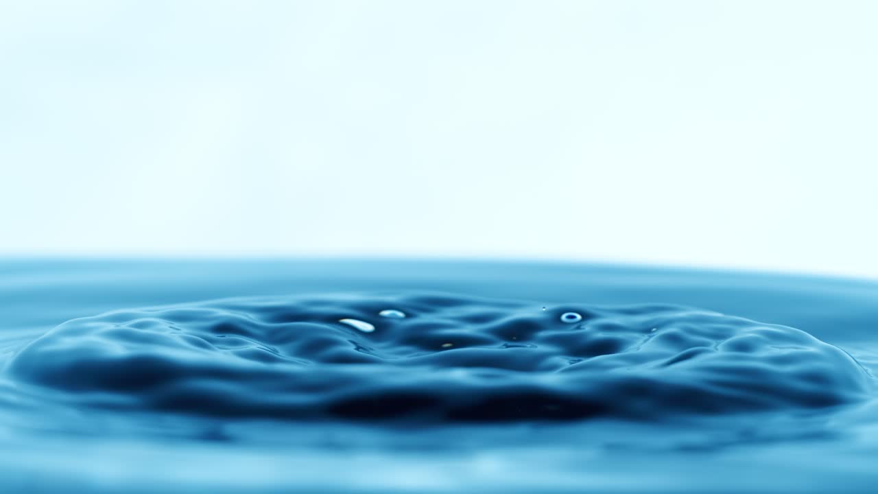 Drop of water falls into a drop of water in a super slow motion. Shot on super slow motion 1600 fps.