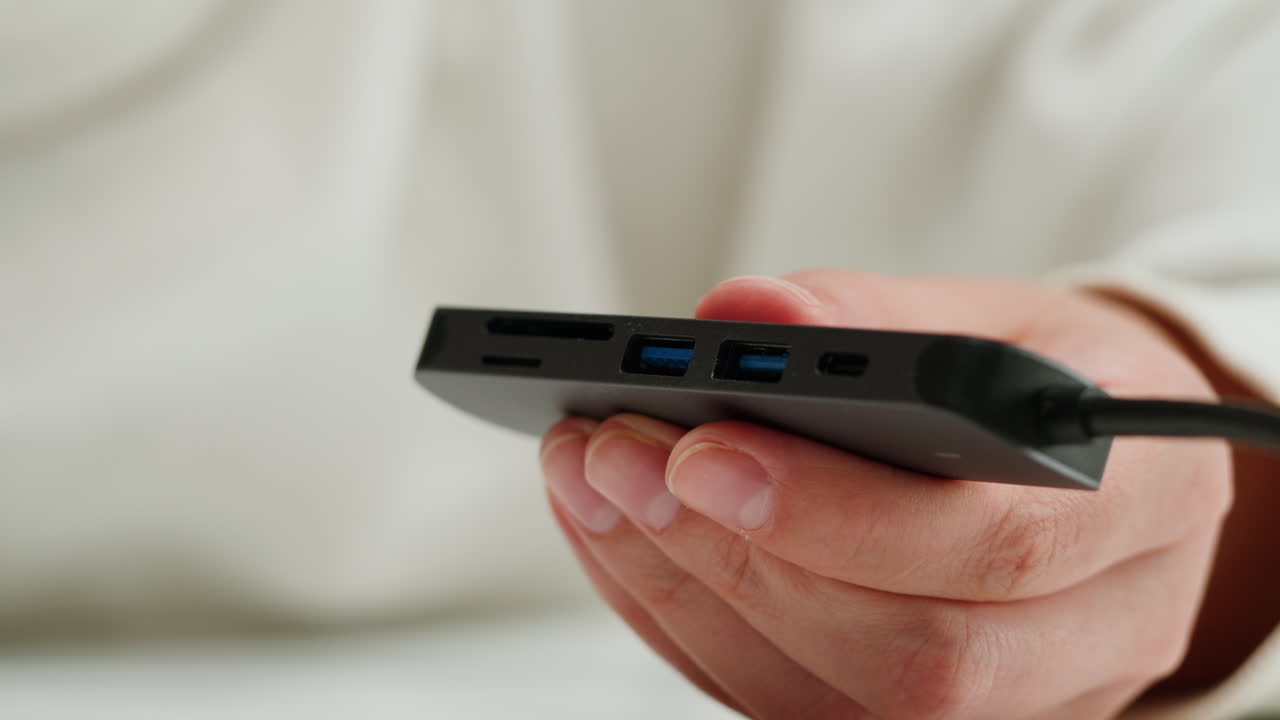 Using special adapter with many various of connector close-up. Adapter with phone, headphones, usb connectors.Tangled wires on table. Trying to untangle many messy cables.