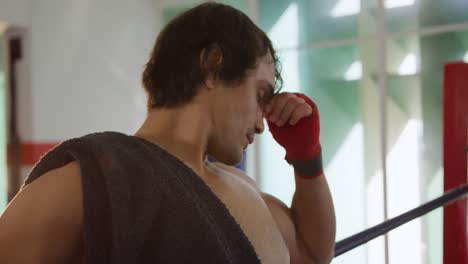 thoughtful caucasian man in boxing ring