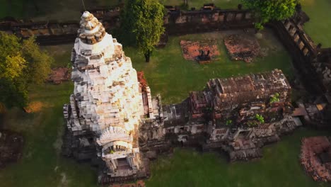 aerial: top down shot of a dome of an ancient temple in thailand at dawn. flying around the dome.