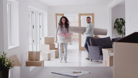 loving couple surrounded by boxes hug as they move into new home together