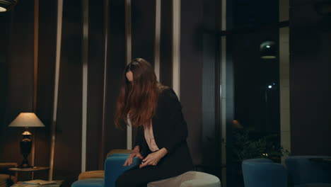 Thoughtful-business-woman-using-laptop-computer-in-hotel-lounge-at-night