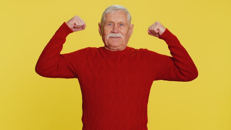 Senior man looking confident showing biceps feeling power strength to fight for rights success win