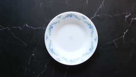 two floral design plates on marble surface