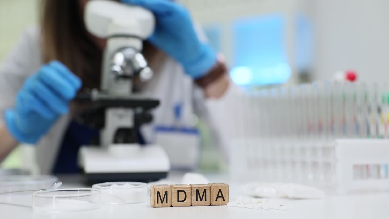 Scientist conducting research on MDMA in a laboratory setting