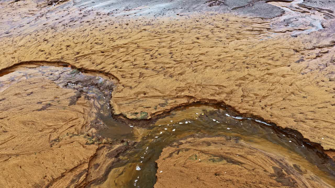 Vista aerea di un fiume che scorre attraverso un paesaggio sedimentario, concetto ambientale di ecosistema acquatico