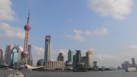 an establishing shot of shanghai china with the huangpu river in foreground