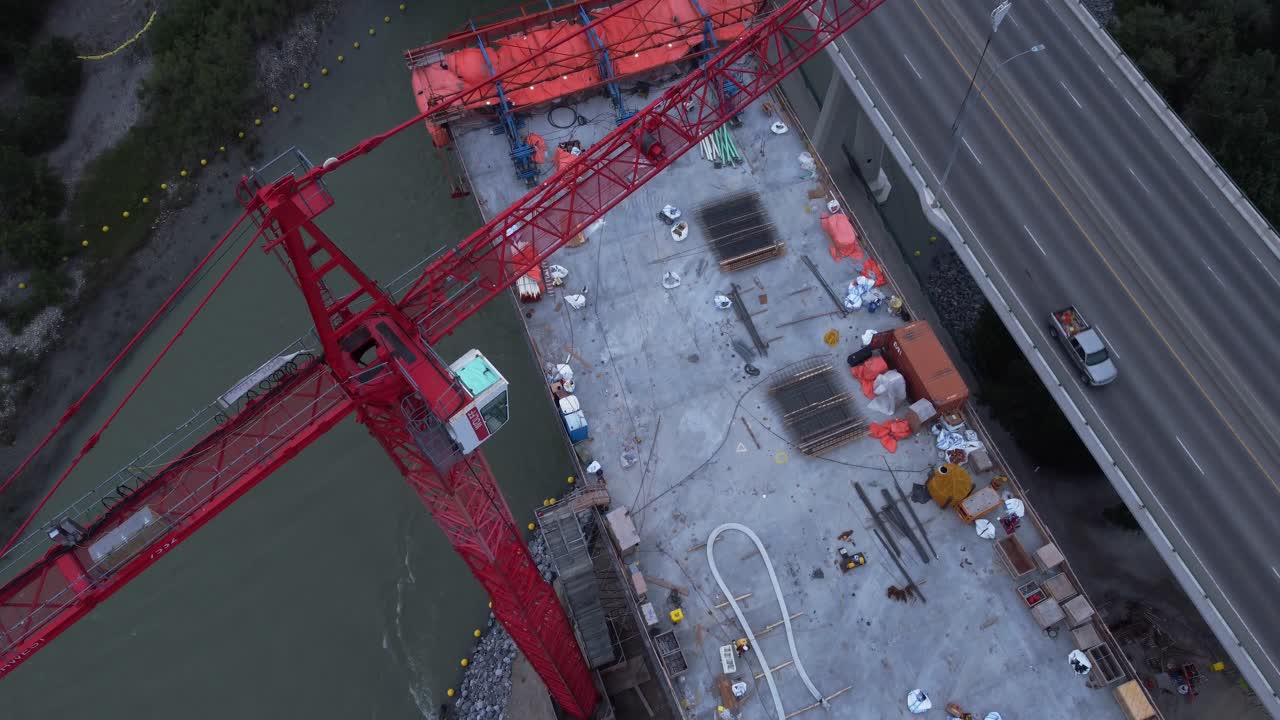 Crane by busy highway bridge construction zone pull down