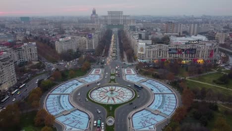 an aerial panoramic view of bulevardul unirii, an important avenue in bucharest with the romanian parliament in the background - romania