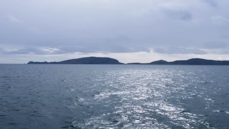 View-from-the-passenger-ferry-from-Barra-overlooking-ocean-and-Isle-of-South-Uist-in-the-Outer-Hebrides-of-Scotland-UK