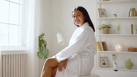 woman in bathrobe relaxing at home