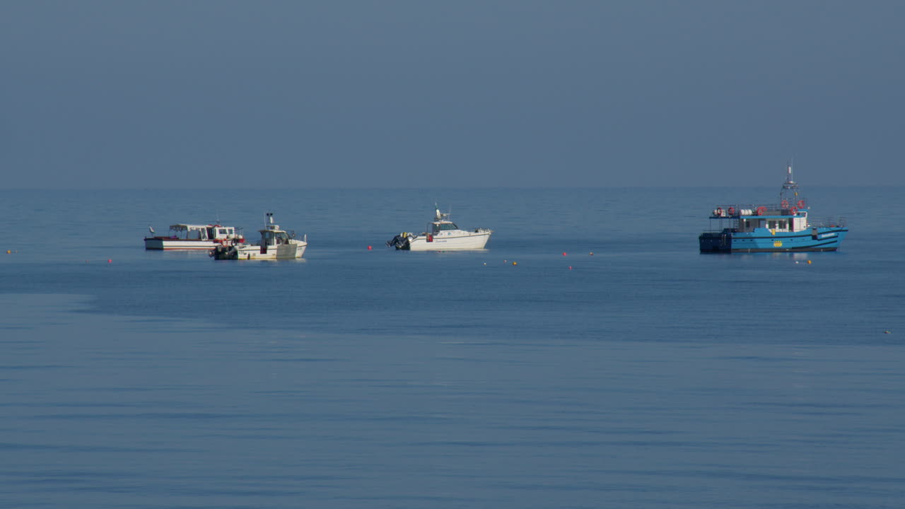 Wide shot of motor boats moored at sea at new quay bay