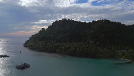 Smooth-aerial-top-view-flight-Boats-anchoring-in-sea,-island-Ko-Kut-Ao-Phrao-beach,-Thailand-2022