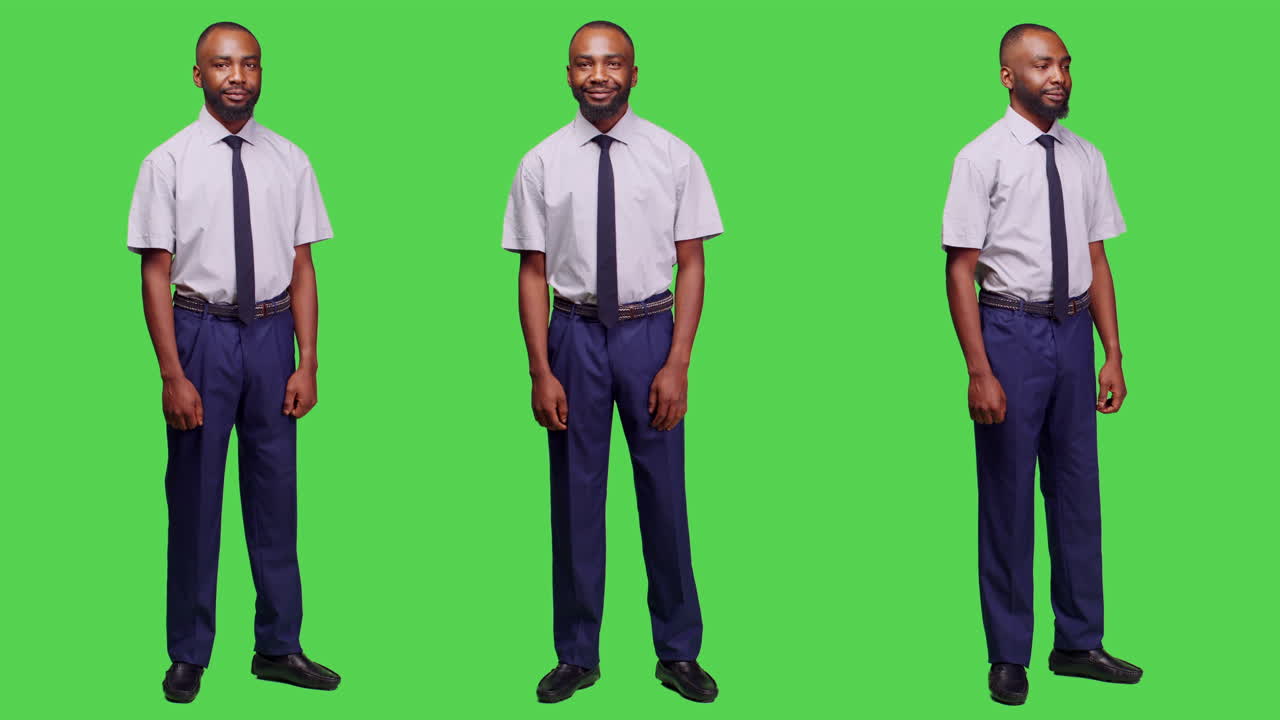 A man wearing a suit in front of a green screen