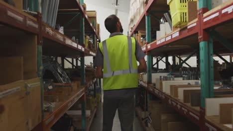 worker walking between two shelves