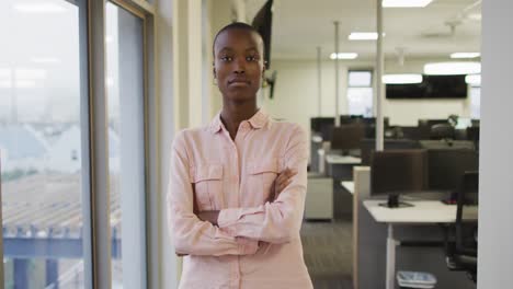 portrait of african american creative businesswoman with crossed hands looking at camera