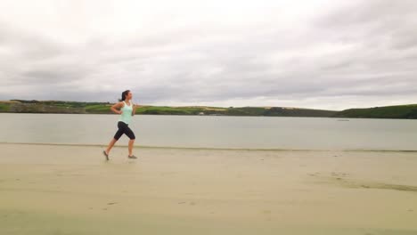 fit woman running on the sand