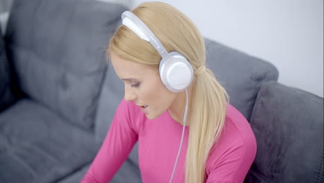 woman listening music from phone using headset