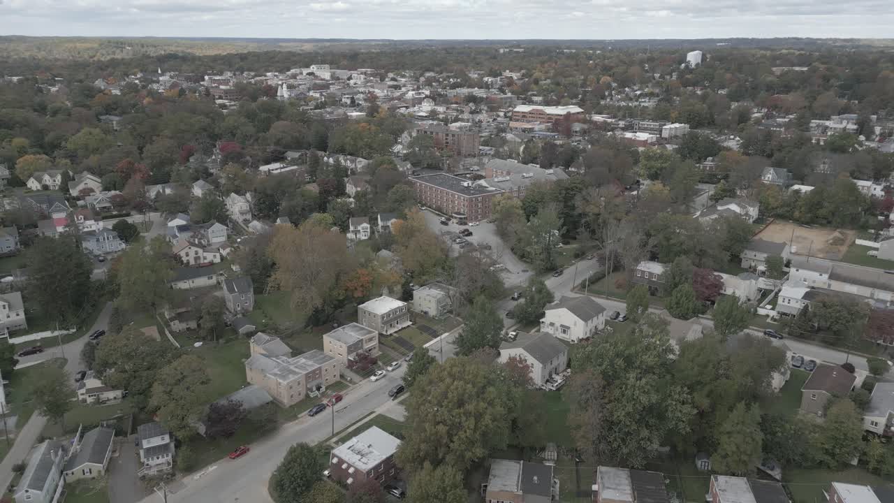Flying over head of a small town full of buildings
