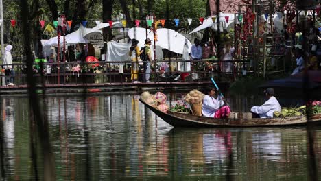 people rowing a boat in a scenic park