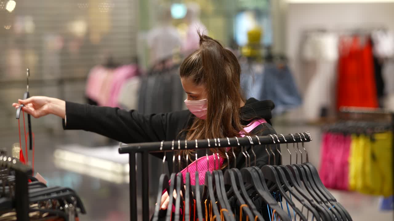 Woman Shopping for Dresses in a Clothing Store