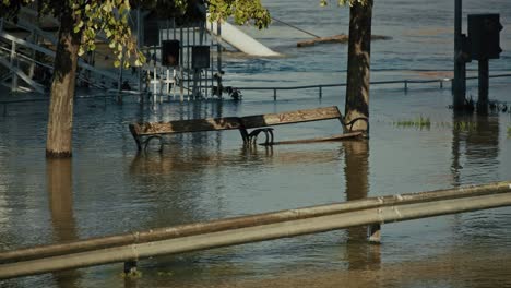 park benches submerged in floodwaters