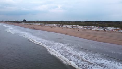 Drone-shot-of-a-coastline-on-North-sea,-with-clouds-in-the-background