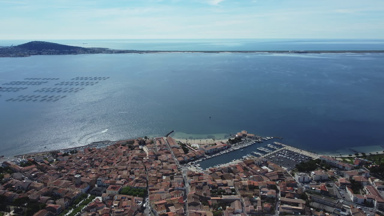 Aerial view of a coastal town with harbor and marina in southern France
