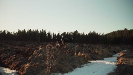 A-Man-Collecting-Dig-Dirt-Using-A-Pail-In-Rural-Nature