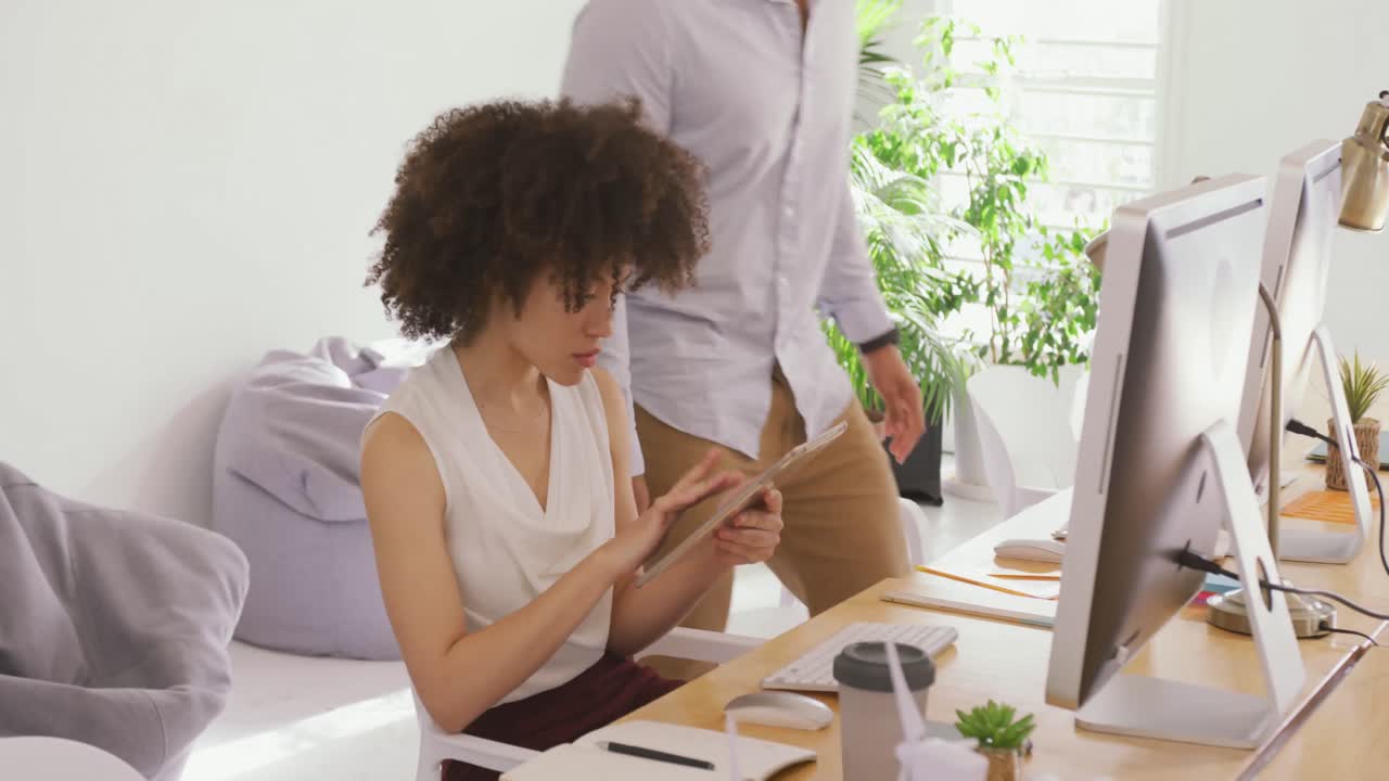Two colleagues working in creative office