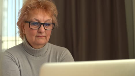Head shot mature woman looking at camera and talking, grandmother chatting with relative online, making video call, middle aged blogger recording vlog, teacher speaking to webcam, distance lecture