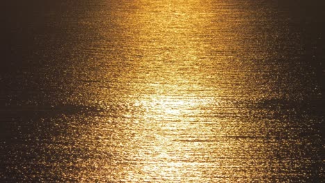 beautiful golden sunset on sea with waves