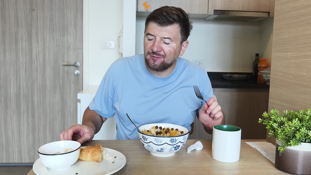 Man eating cereal for breakfast in the kitchen