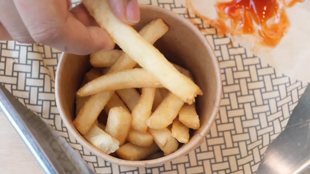 Hand pick french fries on table ,