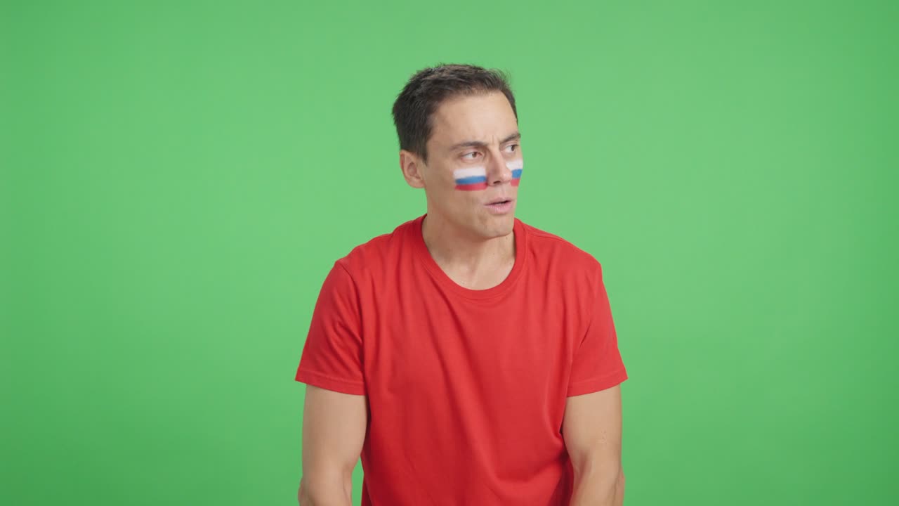 Man cheering for Russia during a match that is lost