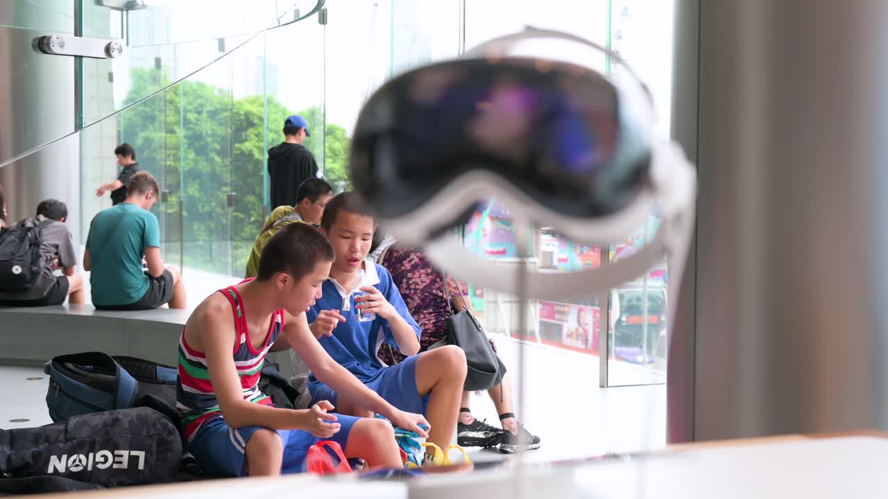 Customers are seen at the American technology giant's Hong Kong store as the Apple Vision Pro mixed-reality headsets are on display.