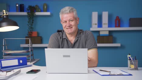 home office worker man winks at camera.