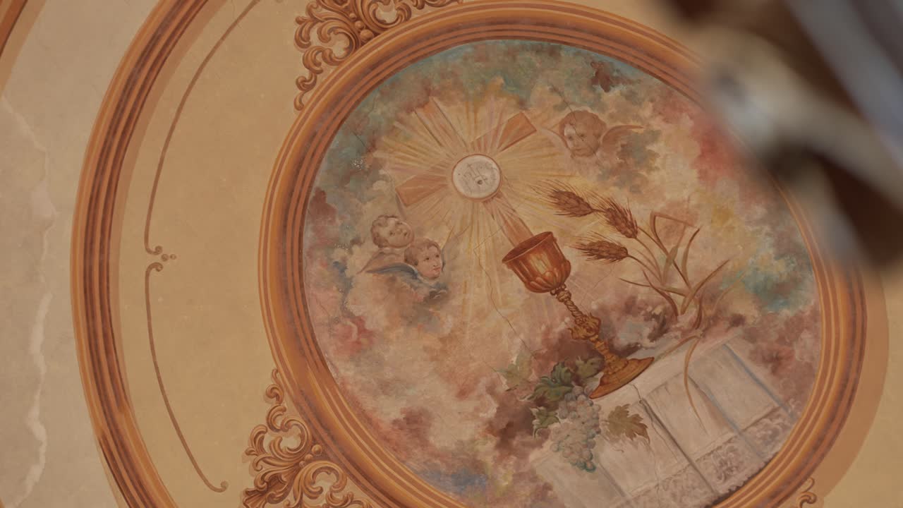 religious ceiling painting with chalice angels wheat and grapes in church