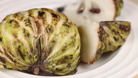 custard apple sliced and displayed on a plate