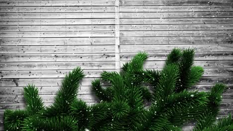 video composition with snow over pine frame on wood