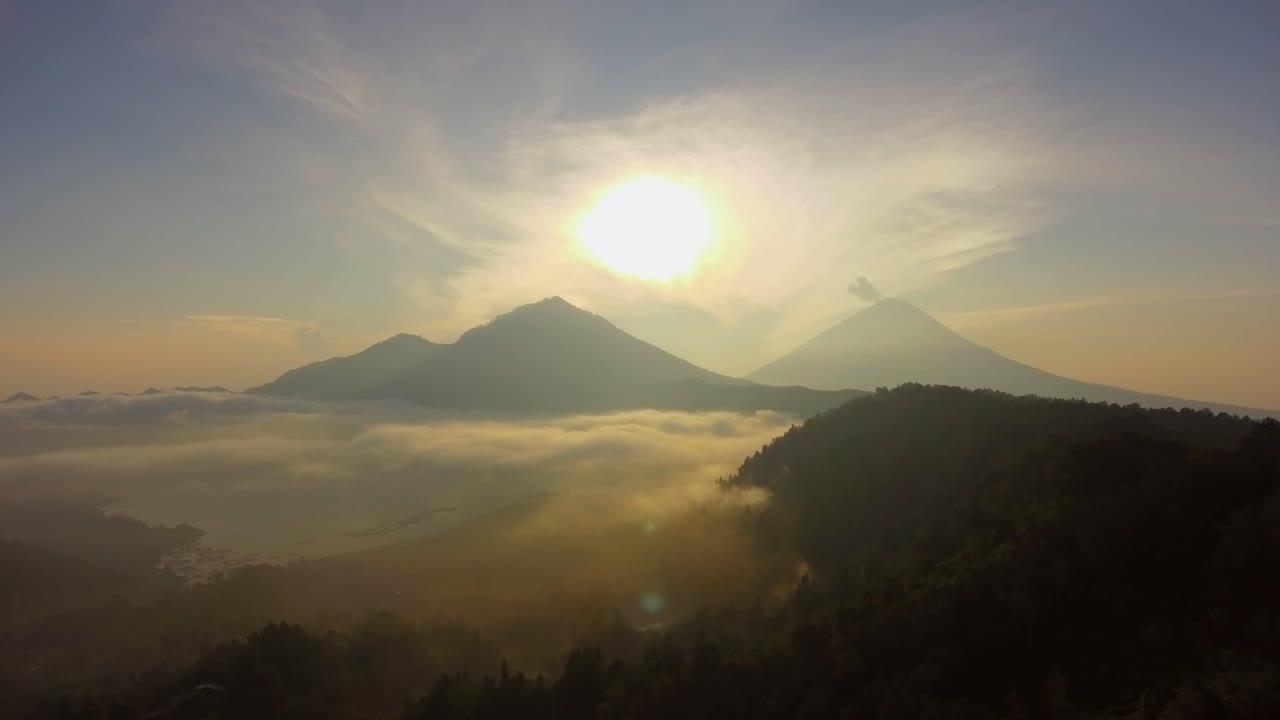 Drone video of sunrise looking at Mount Batur and Mount Agung.