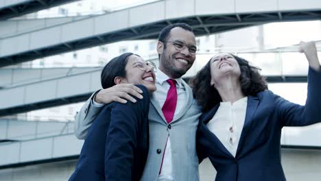 excited business colleagues hugging