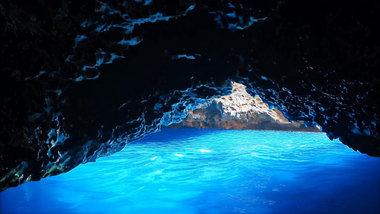 Câmera em movimento dentro de uma caverna rochosa escura revelando água azul e uma formação rochosa iluminada pelo sol mostrando detalhes.