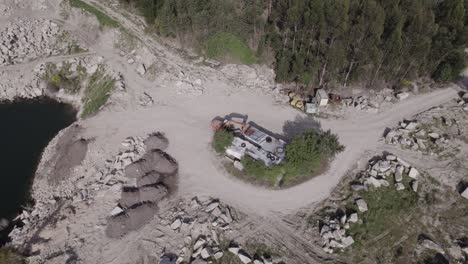 aerial bird's eye view over machinery excavators and bulldozer are digging clay quarry