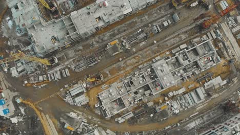 block building site with equipment and construction cranes