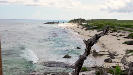 waves from the tropical waters of the gulf of mexico break on a beach along the coastline of cozumel island, mexico